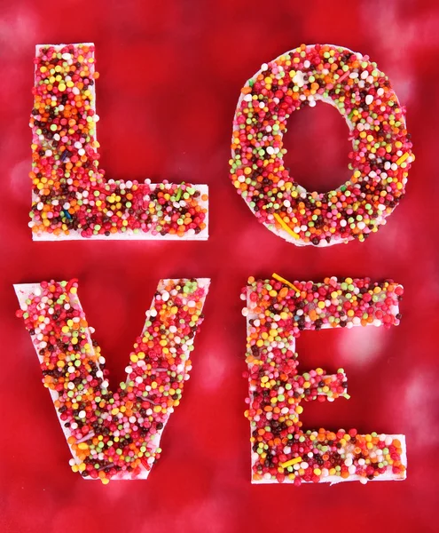 Word Love on red background — Stock Photo, Image