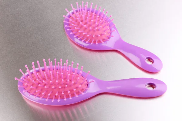 Two purple hair brushes on metalic background — Stock Photo, Image