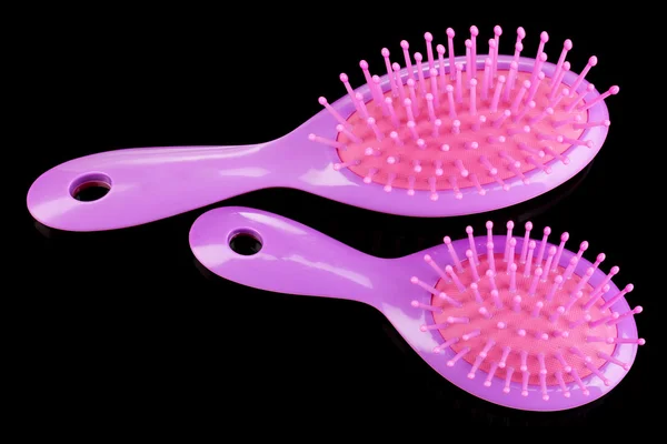 Two purple hair brushes on black background — Stock Photo, Image