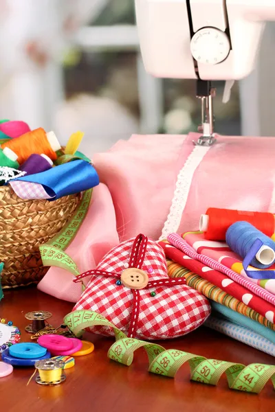 Sewing machine and fabric on bright background — Stock Photo, Image