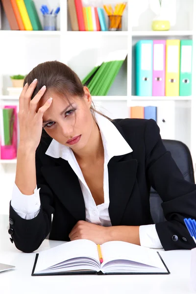 累了的商业女性与她的工作场所中的文档 — 图库照片
