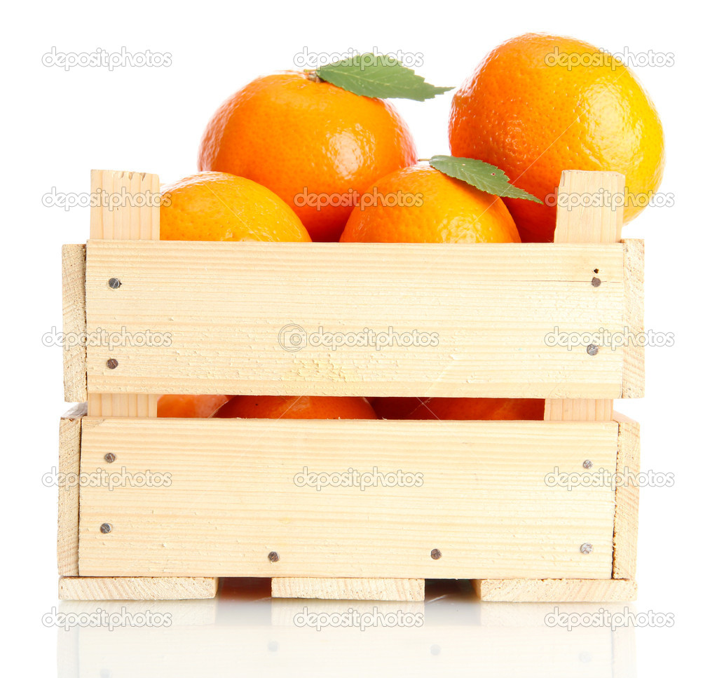 Ripe tasty tangerines with leaves in wooden box isolated on white