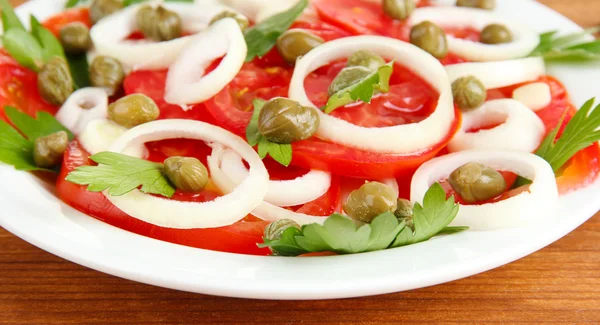 Salad with capers in the plate on wooden background close-up — Stock Photo, Image