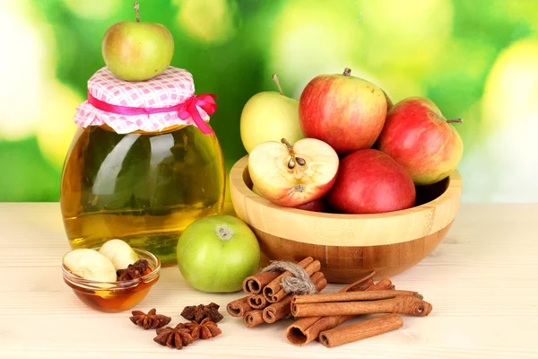 Honey and apples with cinnamon on wooden table on natural background — Stock Photo, Image