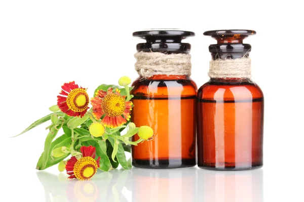 Medicine bottles and flowers isolated on white — Stock Photo, Image