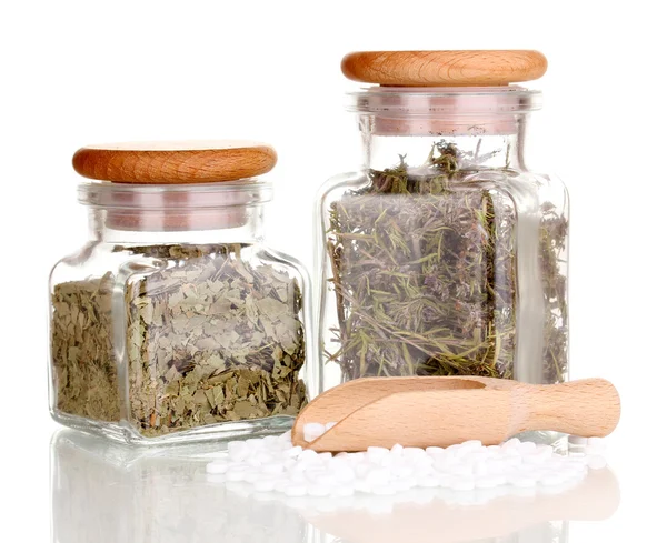 Tablets and bottles with herbs isolated on white — Stock Photo, Image