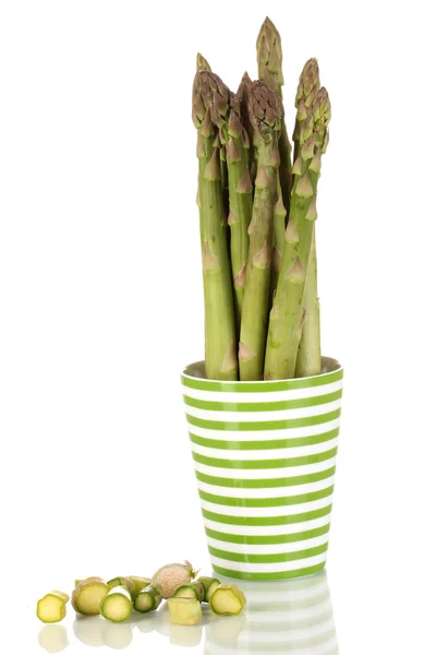 Fresh asparagus in colorful pot isolated on white — Stock Photo, Image