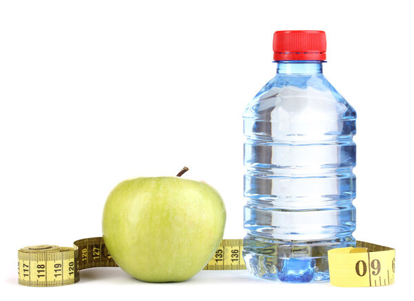 Bottle of water, apple and measuring tape isolated on white