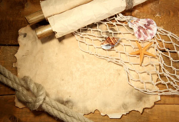 Old paper, fishing net and rope on wooden table — Stock Photo, Image