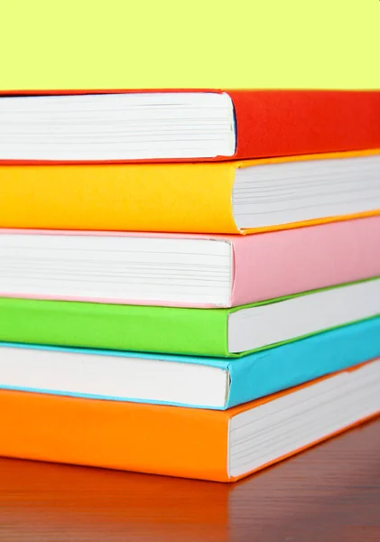 Stack of multicolor books on green background — Stock Photo, Image