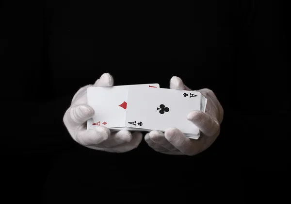 Cards in hands isolated on black — Stock Photo, Image