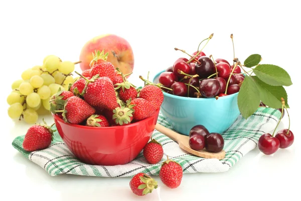 Ripe strawberries and cherry berries in bowls, grapes and apple isolated on white — Stock Photo, Image