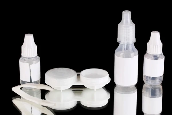 Eye drops and lenses on black background — Stock Photo, Image