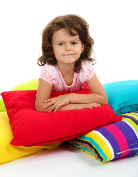 Linda menininha com travesseiros isolados no branco — Fotografia de Stock