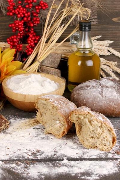 Rye bread on wooden table on wooden background — Stock Photo, Image