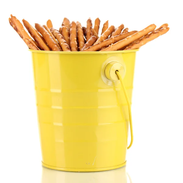 Tasty crispy sticks in yellow pail isolated on white — Stock Photo, Image