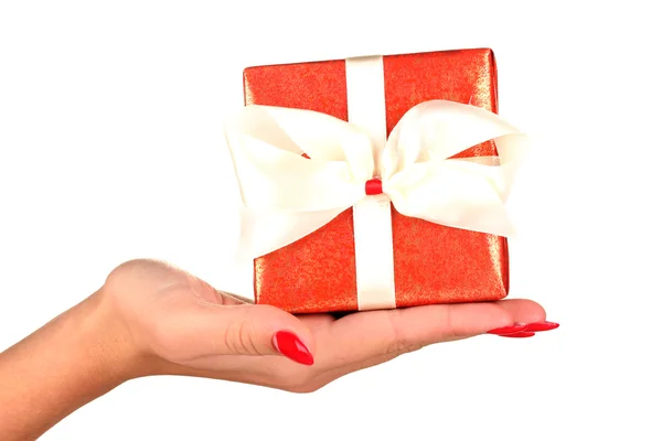 Woman holds box with gift on white background close-up — Stockfoto