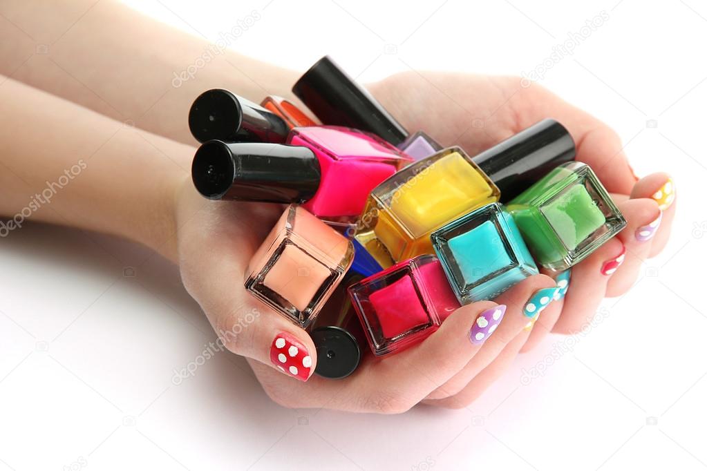 woman hands with nail polishes isolated on white