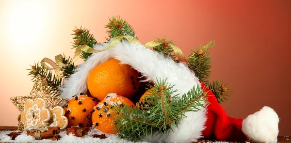 Christmas composition with oranges and fir tree in Santa Claus hat — Stock Photo, Image