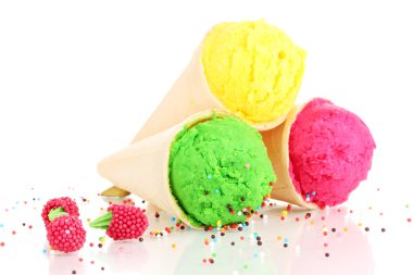 Three scoops of lemon, strawberry and kiwi ice cream in the waffle cones decorated with sprinkles
