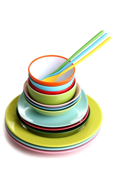 Many colorful plates isolated on white — Stock Photo, Image