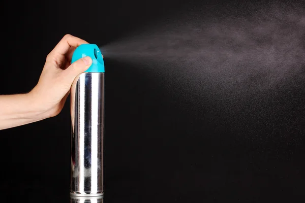 Sprayed air freshener in hand isolated on black — Stock Photo, Image