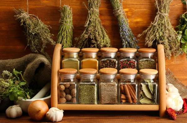 Dried herbs, spices and and pepper, on wooden background — Stock Photo, Image