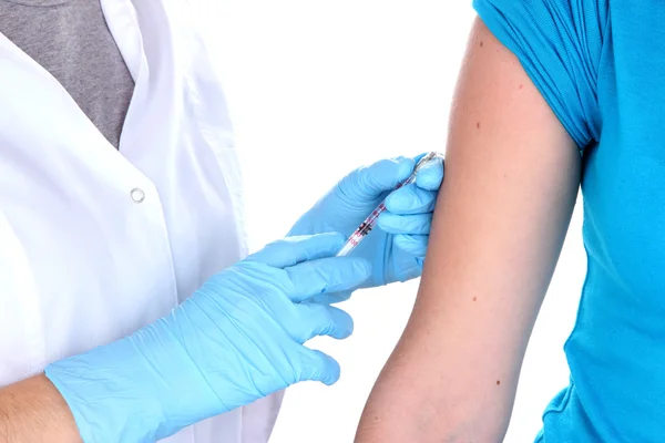 Läkaren håller sprutan med vaccin till patientens knuffa isolerats på vit — Stockfoto