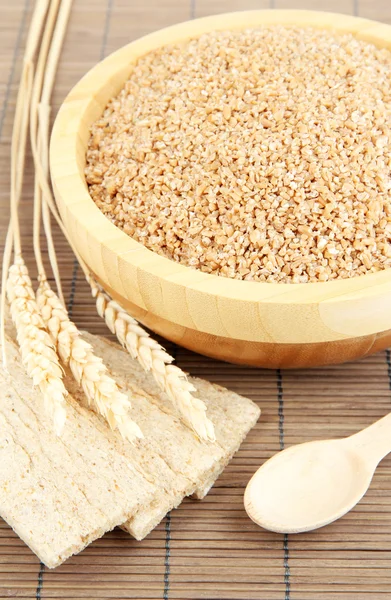 Wooden bowl full of wheat bran — Stock Photo, Image