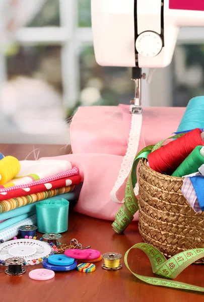 Sewing machine and fabric on bright background — Stock Photo, Image