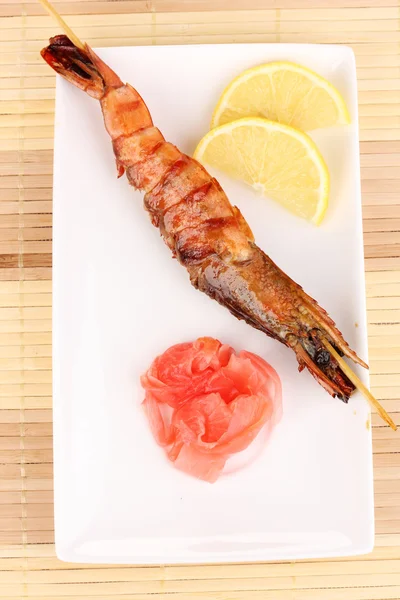 King prawn skewers on plate with ginger and lemon — Stock Photo, Image