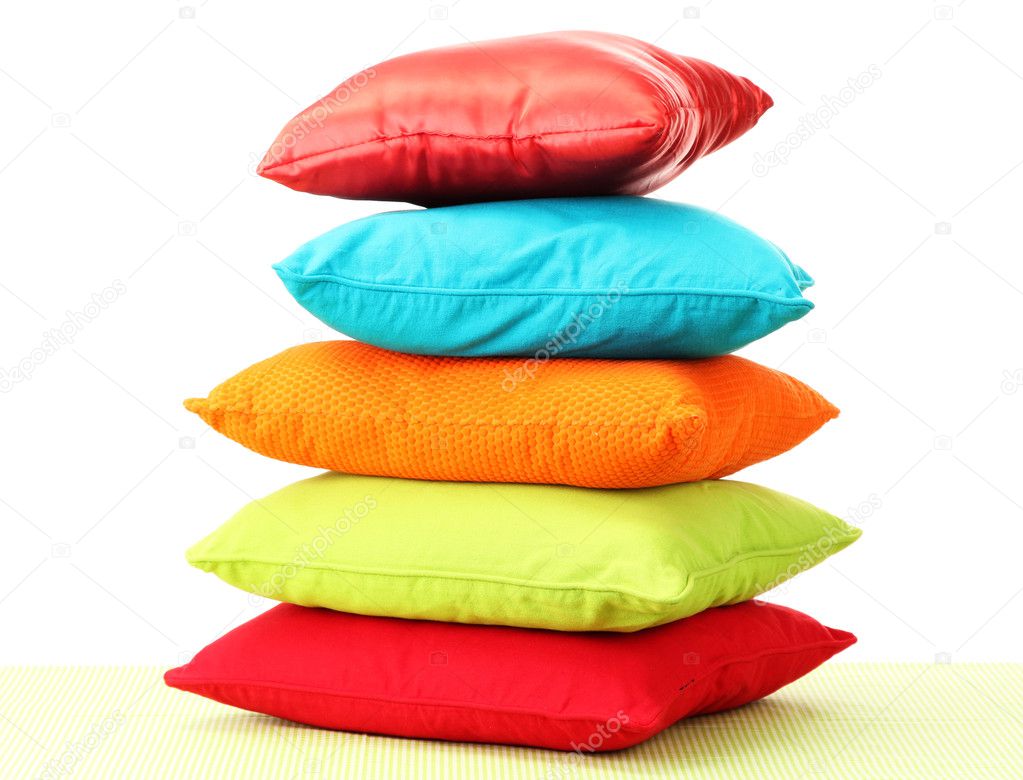 Colorful pillows on table isolated on white