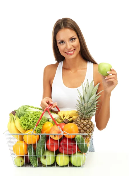 Krásná mladá žena s ovocem a zeleninou v nákupní košík, izolované na bílém — Stock fotografie