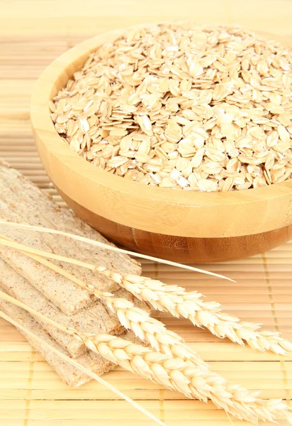 Wooden bowl full of oat flakes — Stock Photo, Image