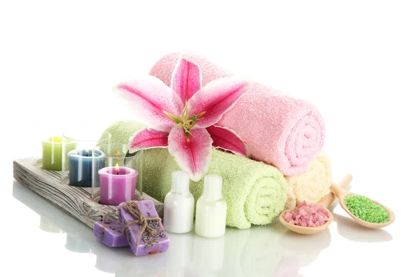 Towels with lily, aroma oil, candles, soap and sea salt isolated on white — Stock Photo, Image