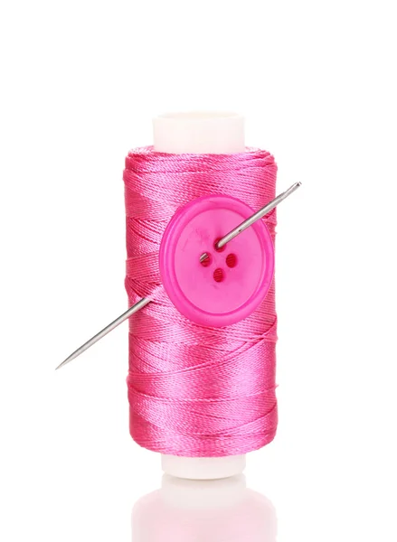 Pink bobbin with needle and buttons isolated on white — Stock Photo, Image