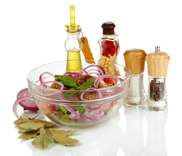 A large piece of pork marinated in bowl with herbs, spices and cooking oil isolated on white — Stock Photo, Image