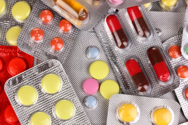 Capsules and pills packed in blisters close-up background — Stock Photo, Image