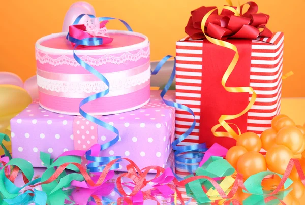 Colorful gift boxes on orange background — Stock Photo, Image