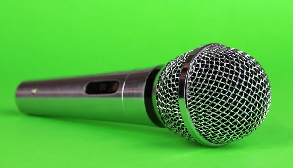 Silver microphone on green background — Stock Photo, Image