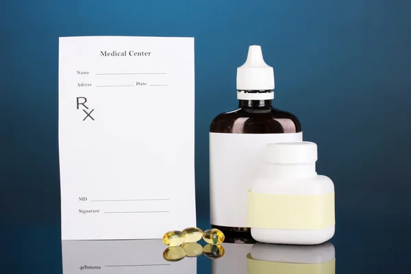 Pharmacist prescription with drops and pills isolated on blue — Stock Photo, Image