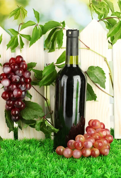 A bottle of wine on the fence background close-up — Stock Photo, Image