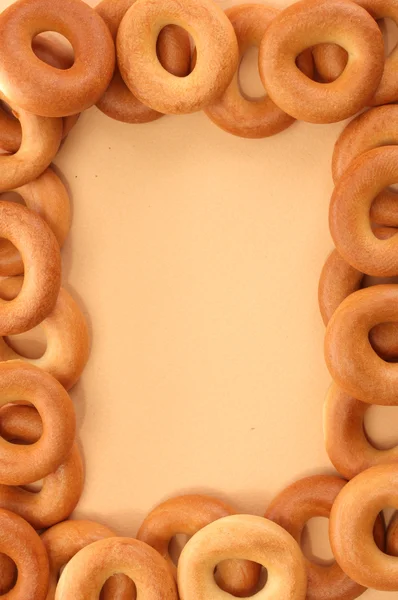 Tasty bagels, on beige background — Stock Photo, Image