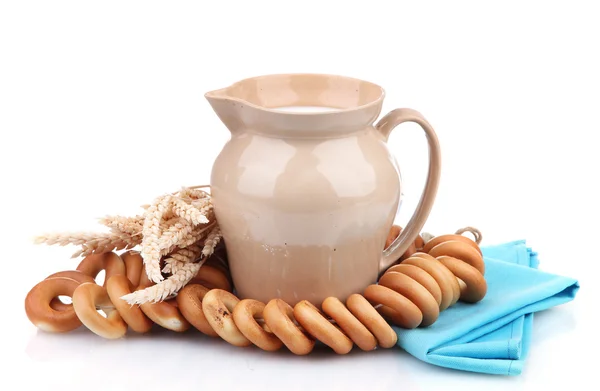 Jar of milk, tasty bagels and spikelets, isolated on white — Stock Photo, Image