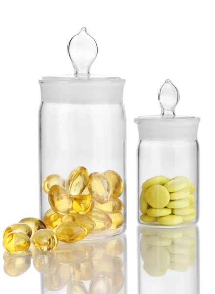 Capsules and pills in receptacles isolated on white — Stock Photo, Image