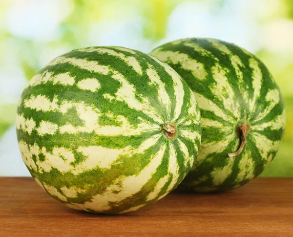 Reife Wassermelonen auf grünem Hintergrund Nahaufnahme — Stockfoto