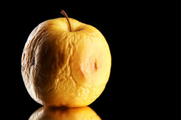Yellow apple as problem skin concept, on black background — Stock Photo, Image