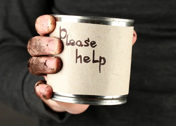 Homeless man asks for help, on black background close-up — Stock Photo, Image