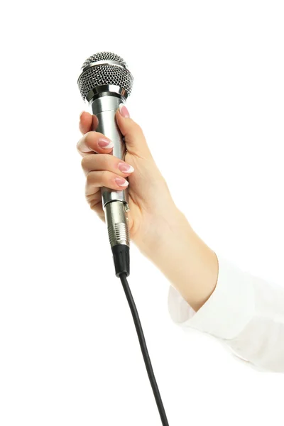 Mano femenina con micrófono aislado en blanco — Foto de Stock