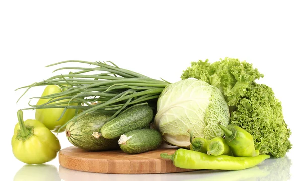 Fresh green vegetables on chopping board isolated on white — Stock Photo, Image